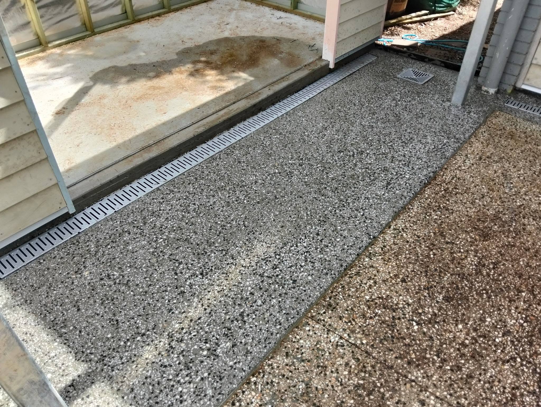 Salt and pepper exposed aggregate pathway with flush drainage