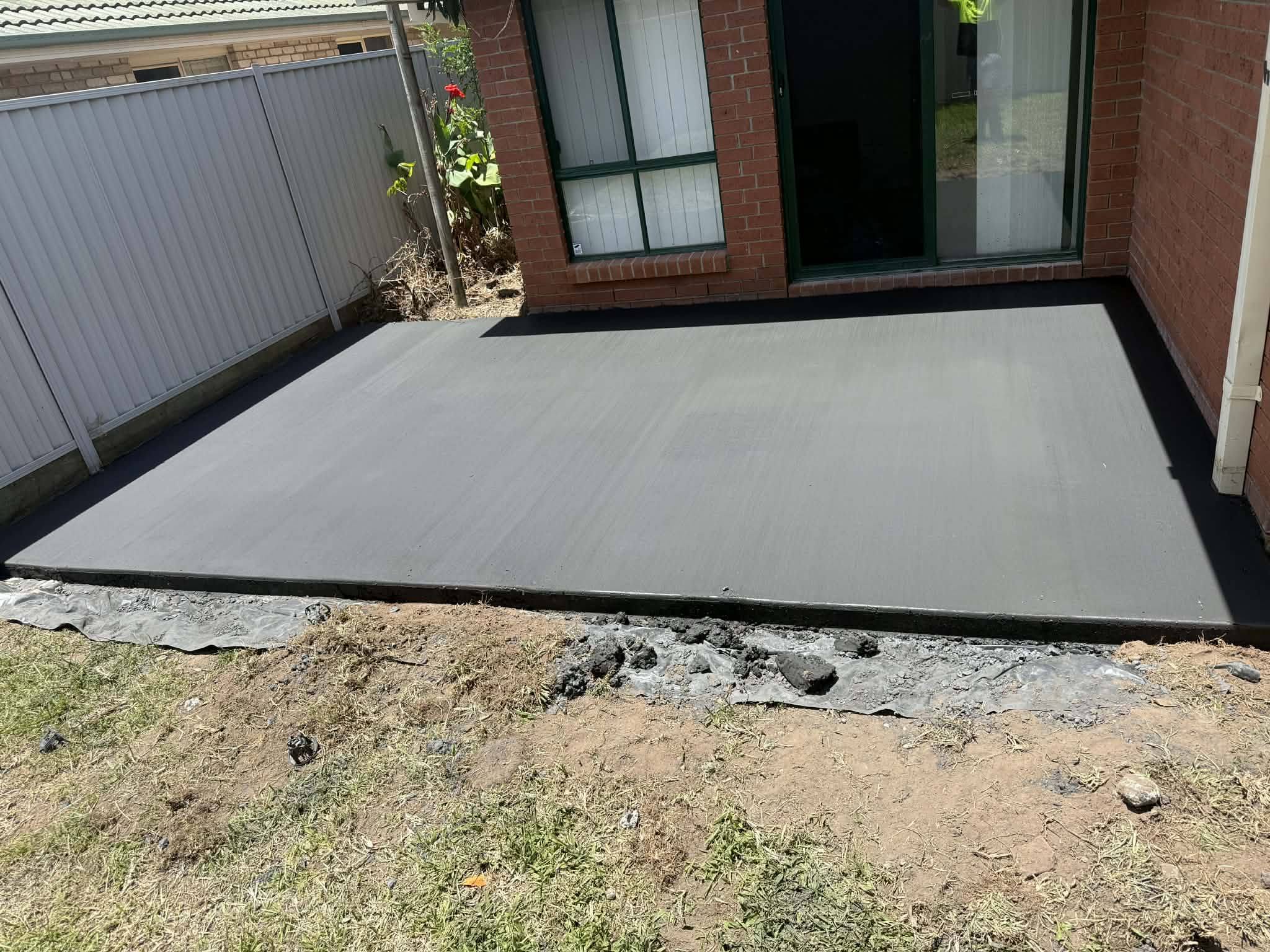 Charcoal coloured concrete patio slab