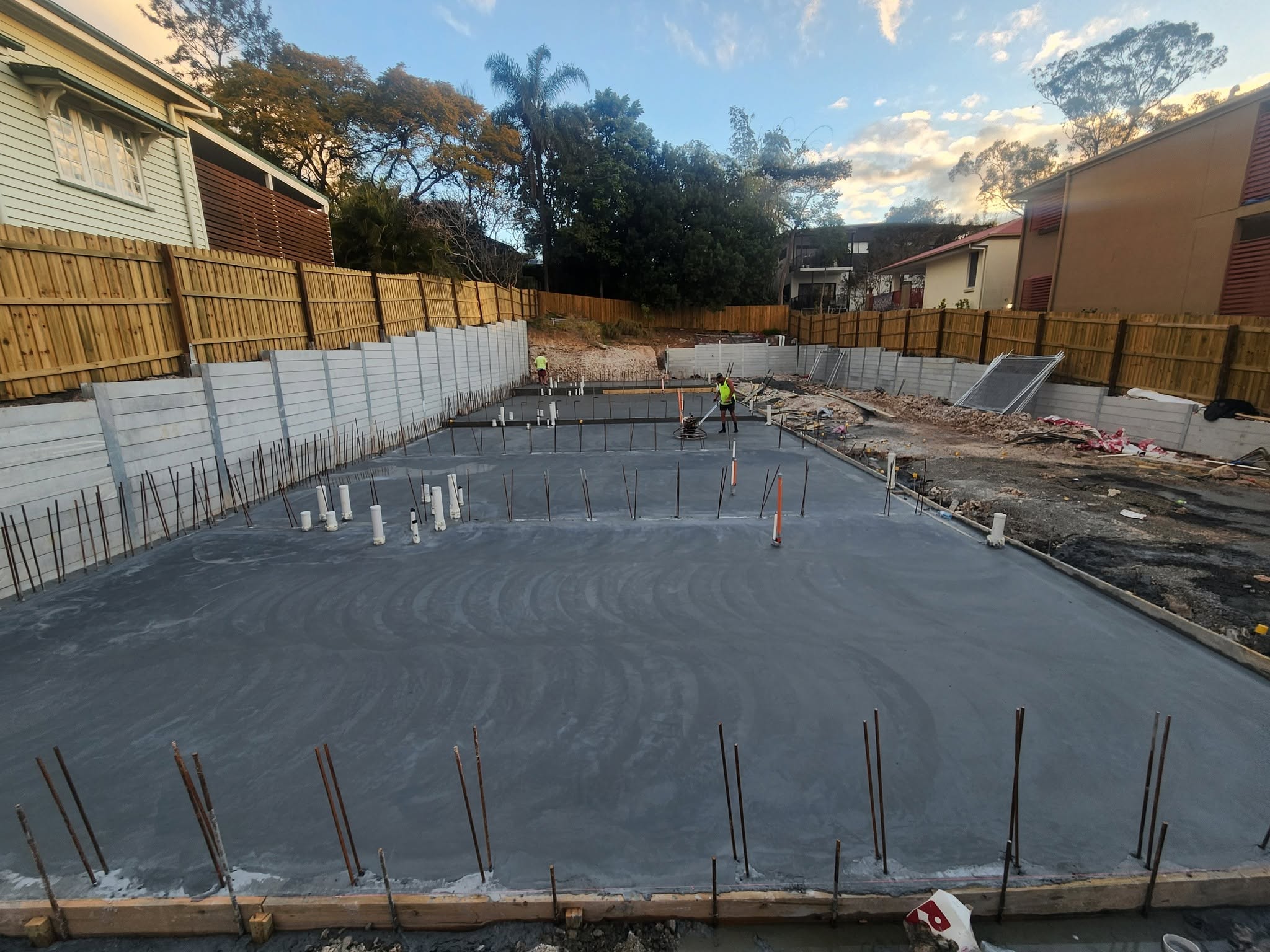 Cantwell crew finishing a full residential house slab at dusk