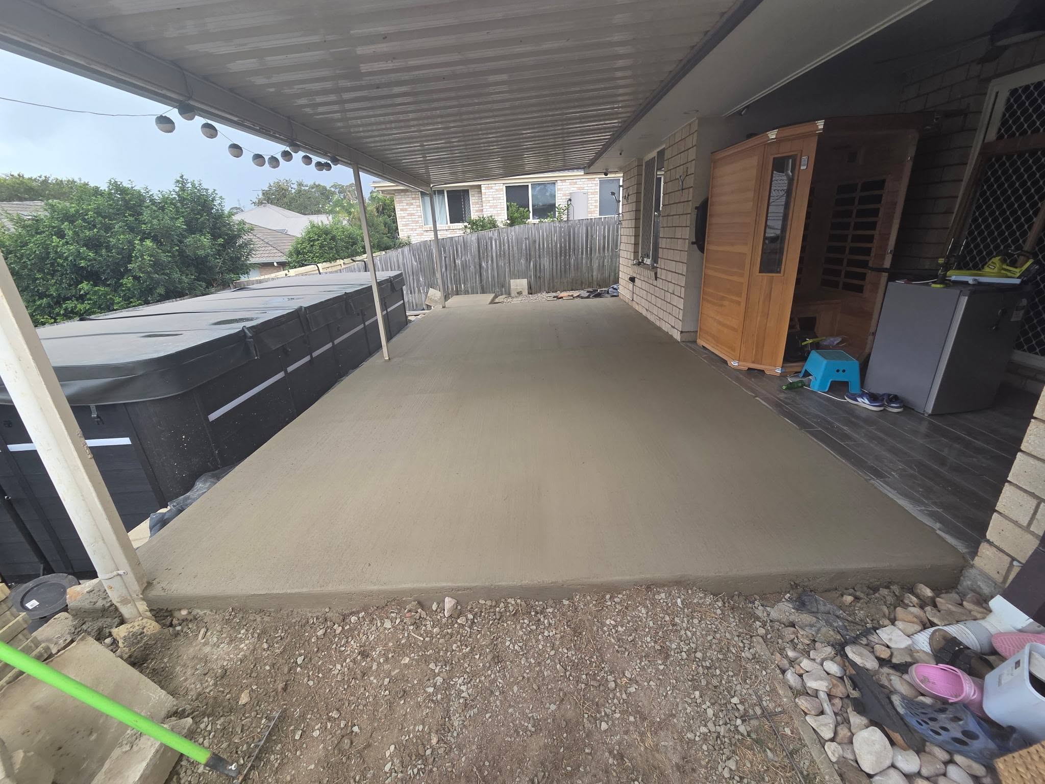 Covered patio slab poured beside an outdoor spa