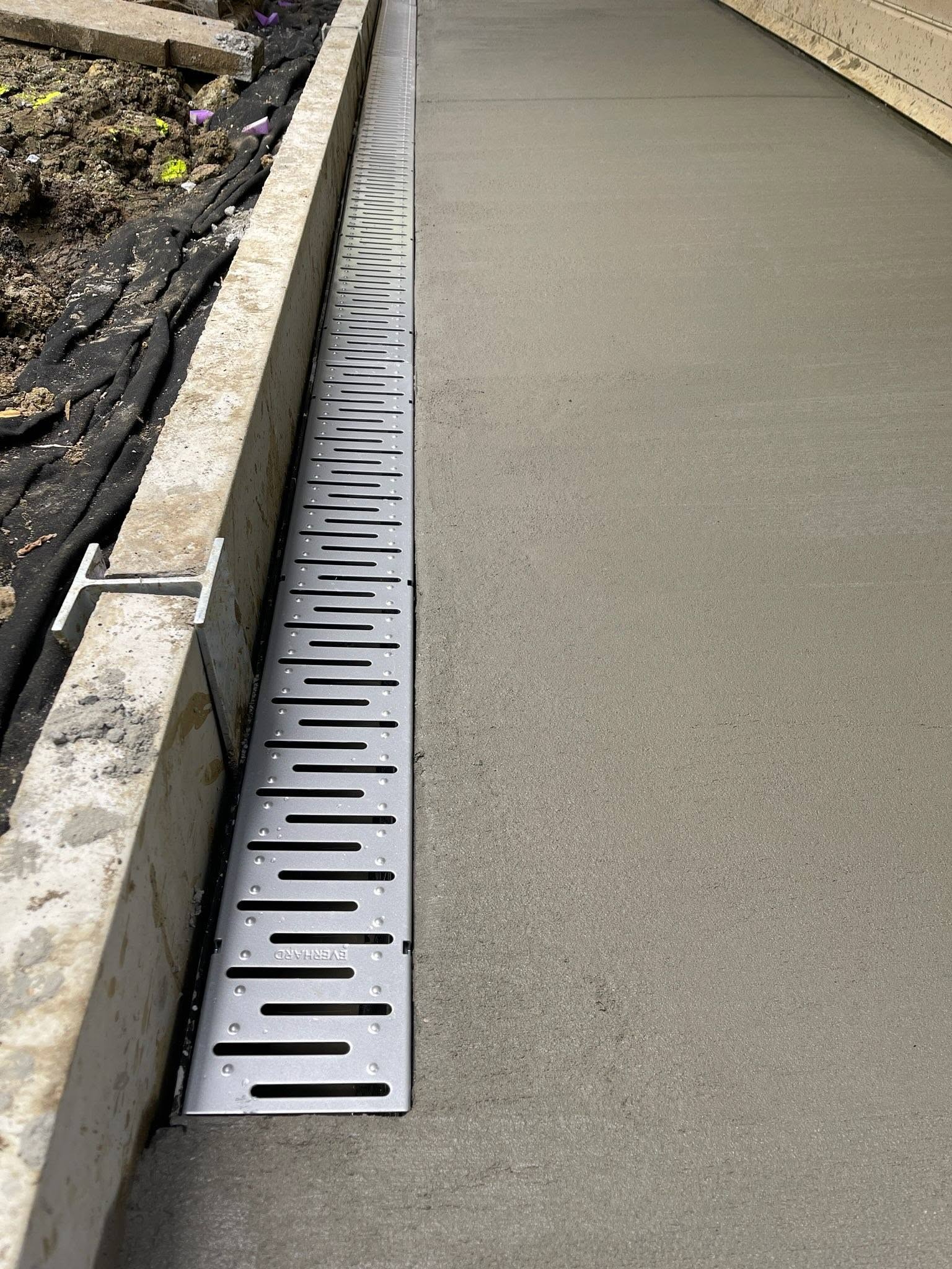 Fresh slab with strip drainage installed flush